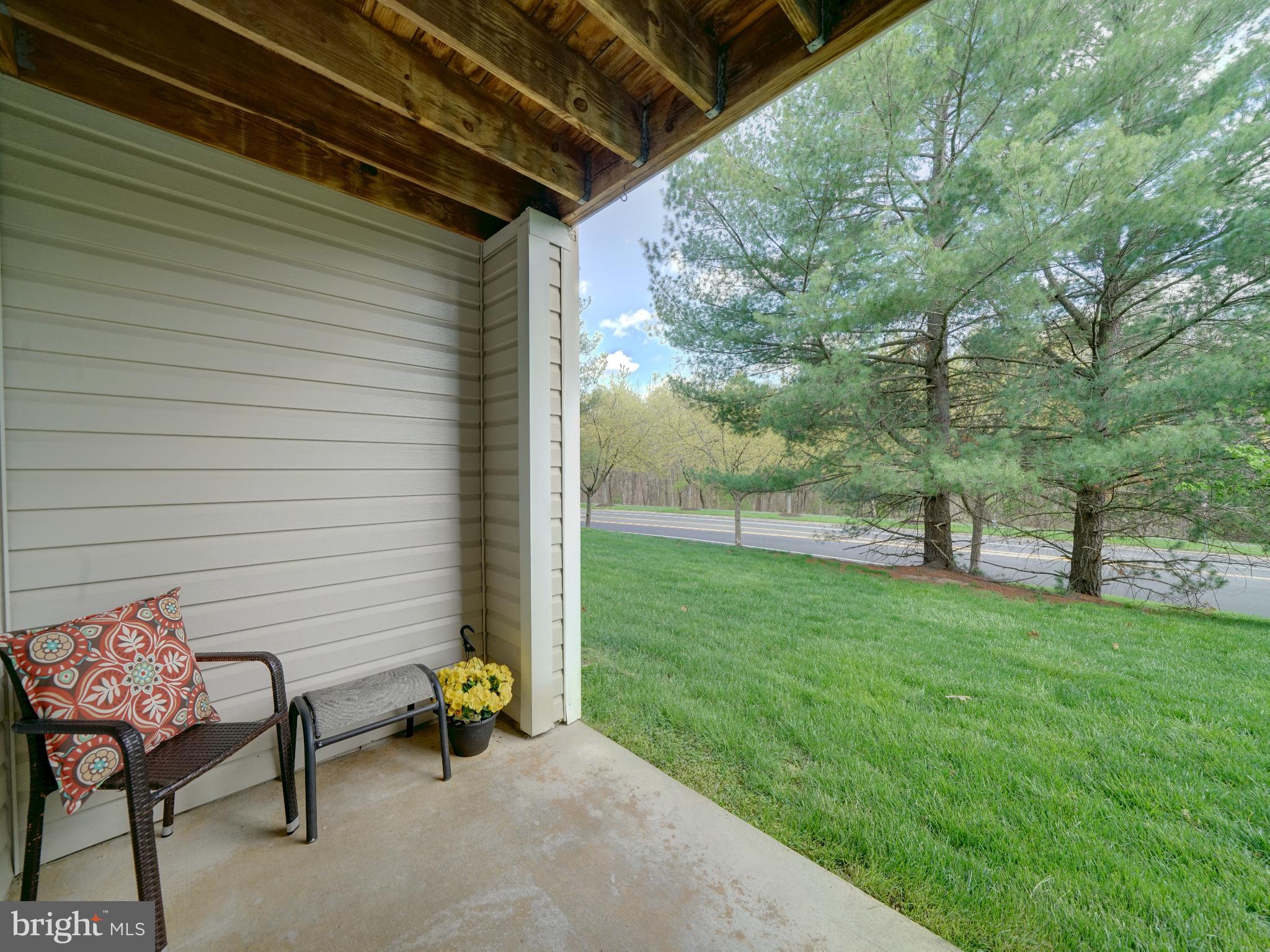693 Winding Stream Way, Unit 103 Odenton, MD 21113 - Photo 21 of 26 a view of a patio with table and chairs and a barbeque