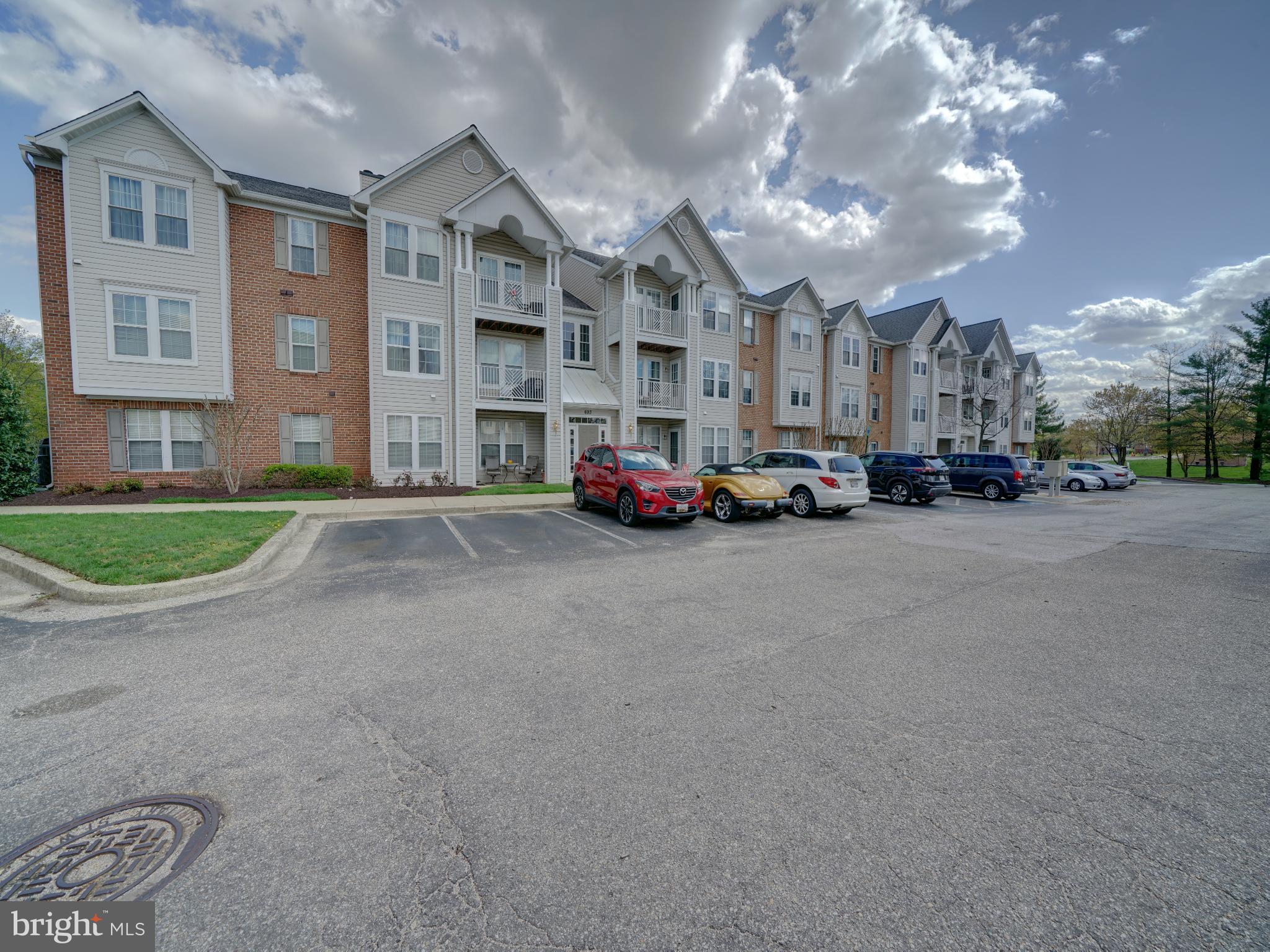 693 Winding Stream Way, Unit 103 Odenton, MD 21113 - Photo 23 of 26 a view of a cars parked in front of a building