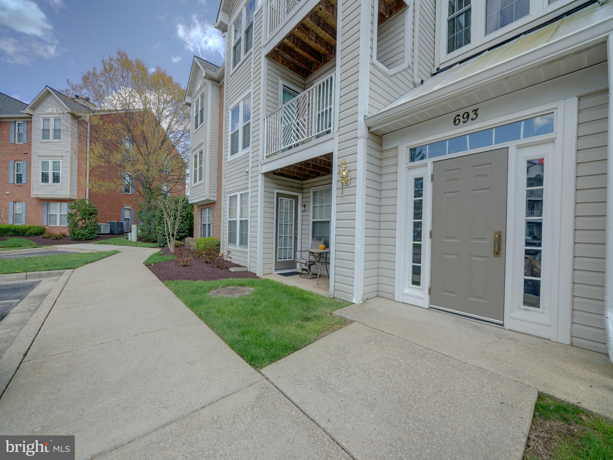 693 Winding Stream Way, Unit 103 Odenton, MD 21113 - Photo 24 of 26 front view of a brick house with a yard
