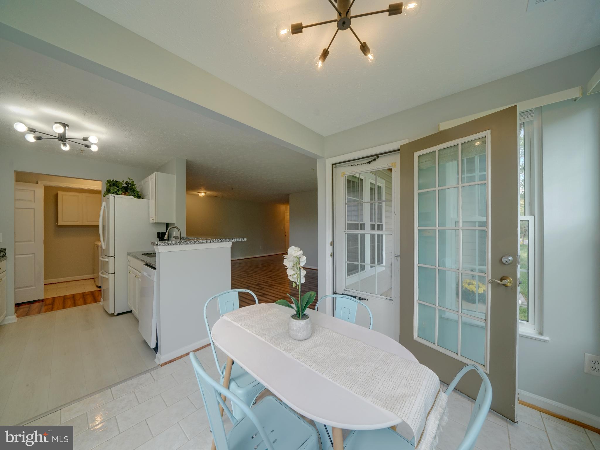 693 Winding Stream Way, Unit 103 Odenton, MD 21113 - Photo 6 of 26 a view of kitchen with furniture and wooden floor