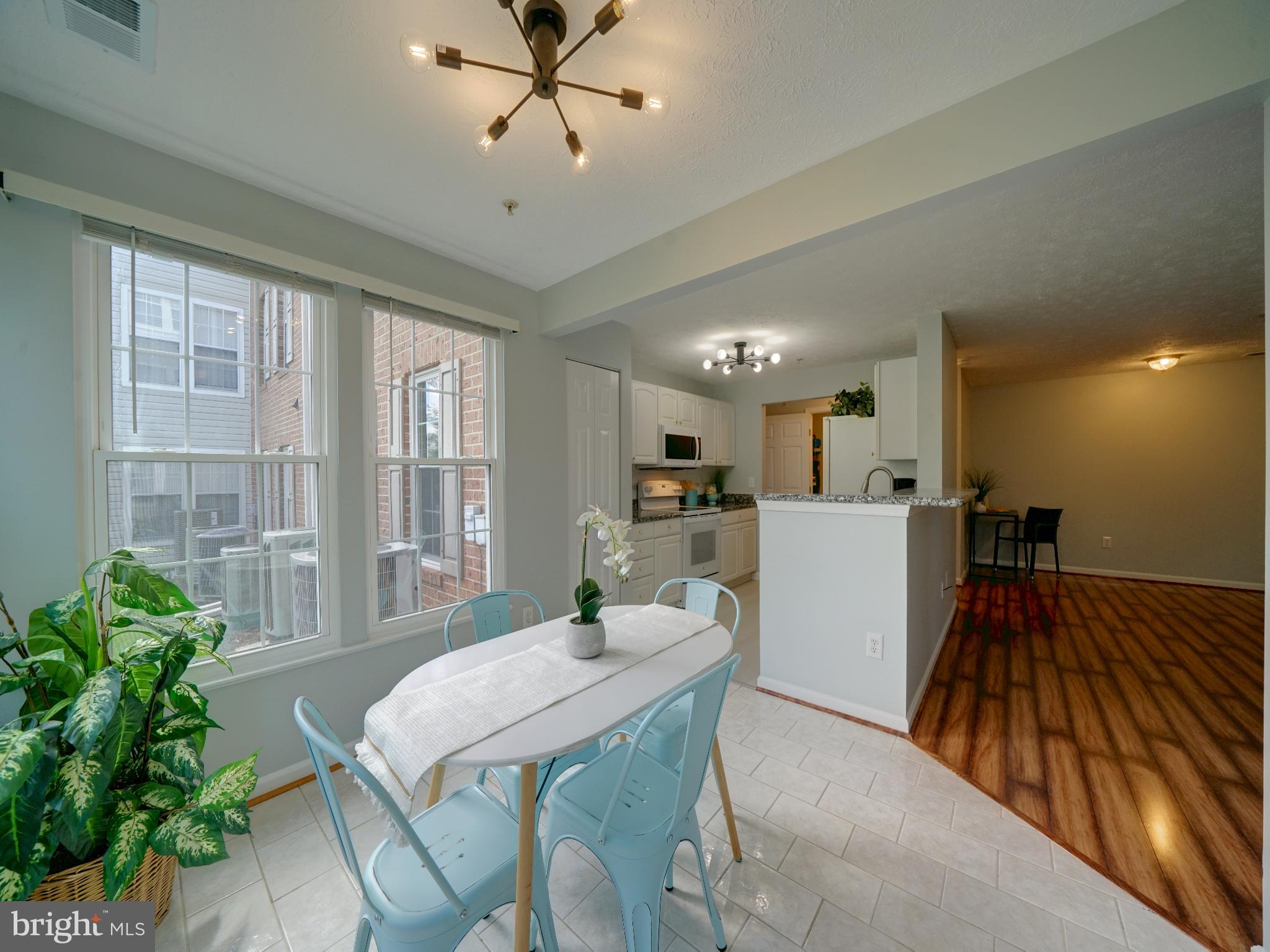 693 Winding Stream Way, Unit 103 Odenton, MD 21113 - Photo 7 of 26 a view of a dining room with furniture window and wooden floor