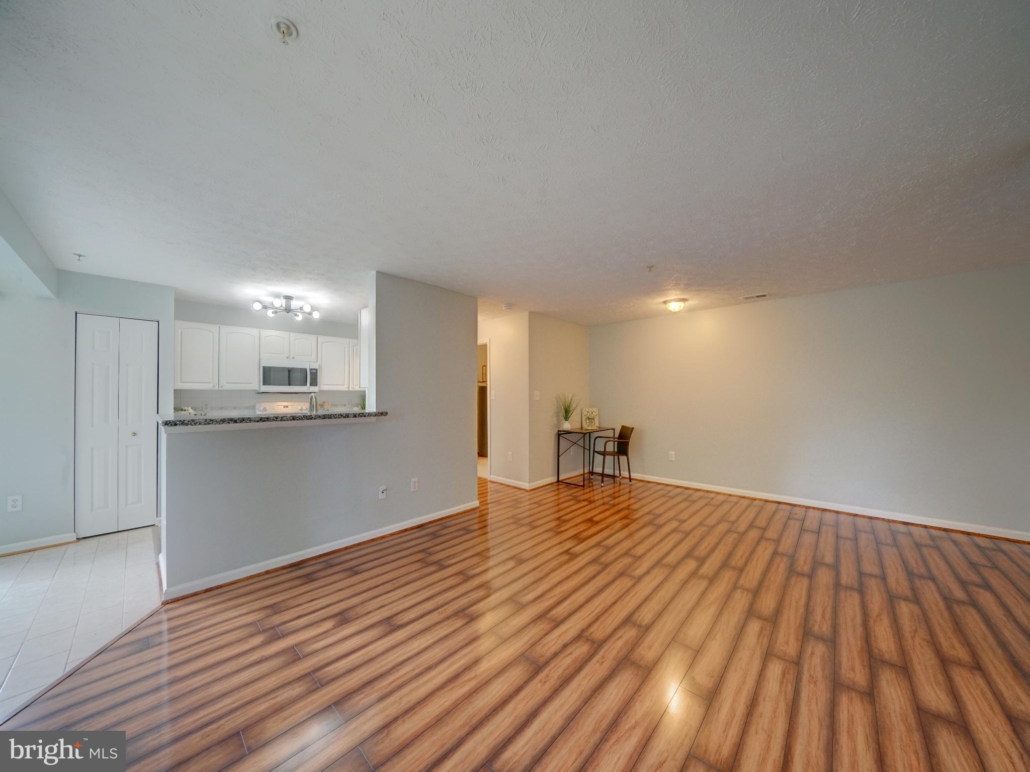 693 Winding Stream Way, Unit 103 Odenton, MD 21113 - Photo 8 of 26 a view of empty room with wooden floor