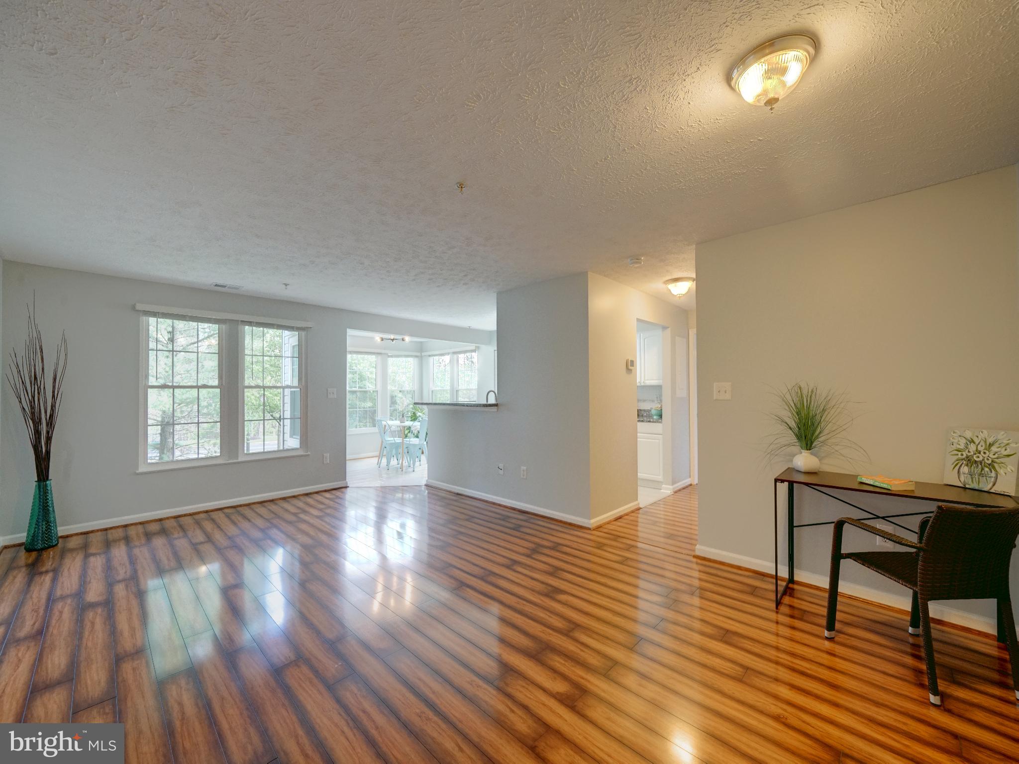 693 Winding Stream Way, Unit 103 Odenton, MD 21113 - Photo 9 of 26 a view of empty room with wooden floor and fan