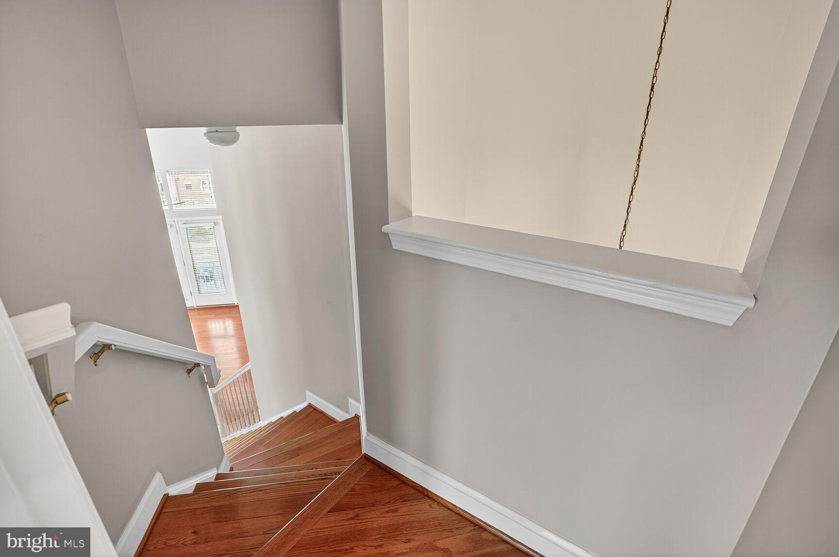 12000 Market Street, Unit 490 Reston, VA 20190 - Photo 25 of 43 Elegant (circular?) staircase with natural light.