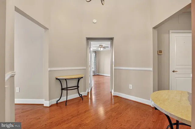a view of a room with wooden floor and a bathroom