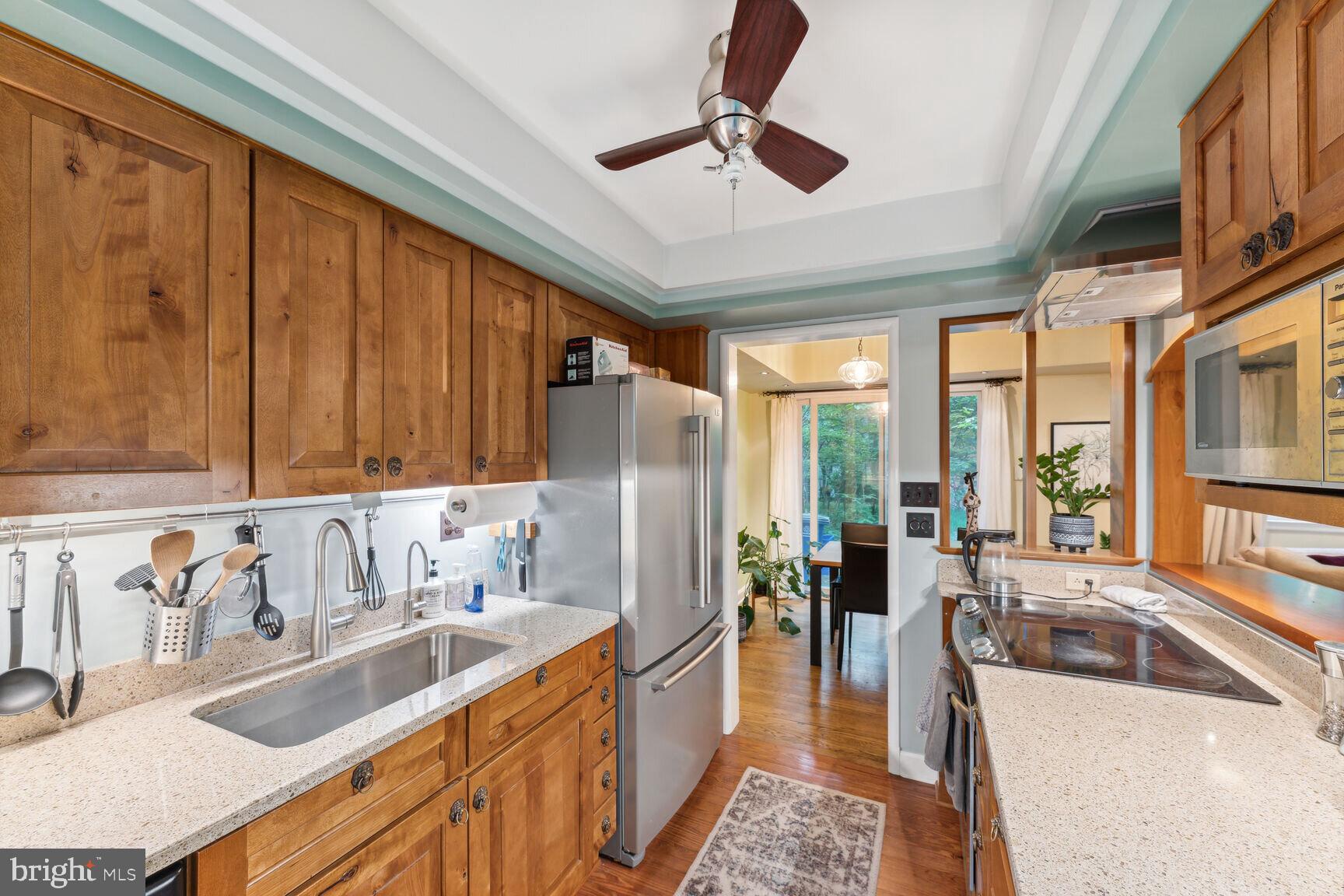 8532 Geren Road, Unit 174 Silver Spring, MD 20901 - Photo 6 of 12 a kitchen with stainless steel appliances granite countertop a sink stove and a refrigerator