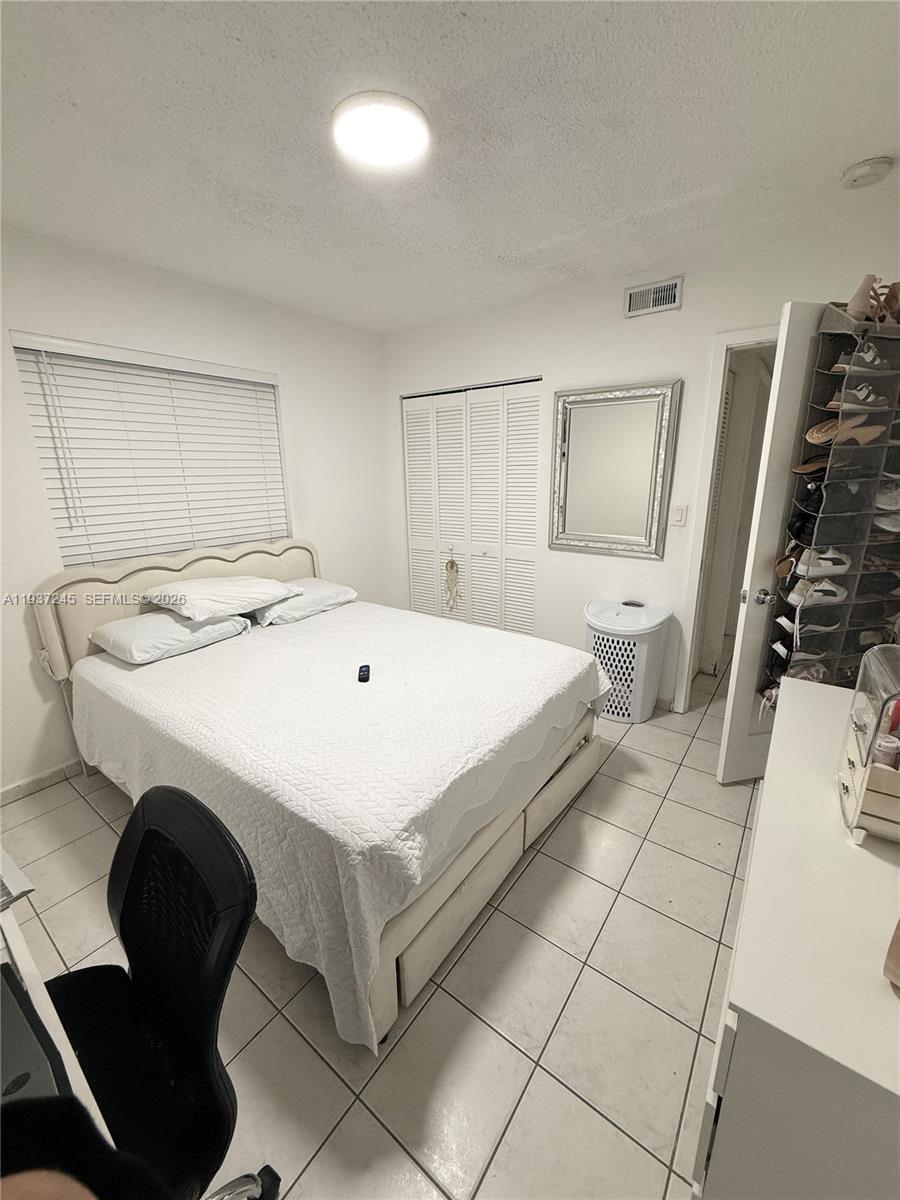 3262 West 70th Street, Unit 101 Hialeah, FL 33018 - Photo 12 of 20 a bedroom with a bed and a stove