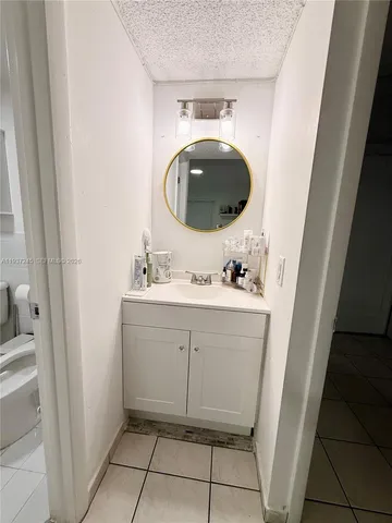 a bathroom with a sink vanity and mirror