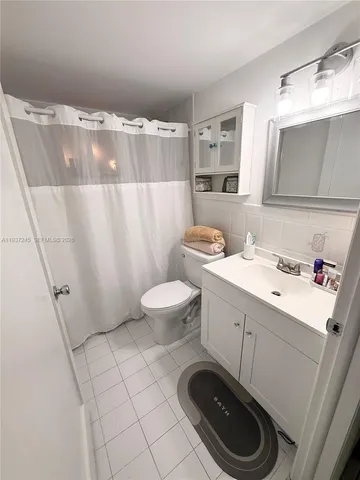 a bathroom with a sink toilet and mirror