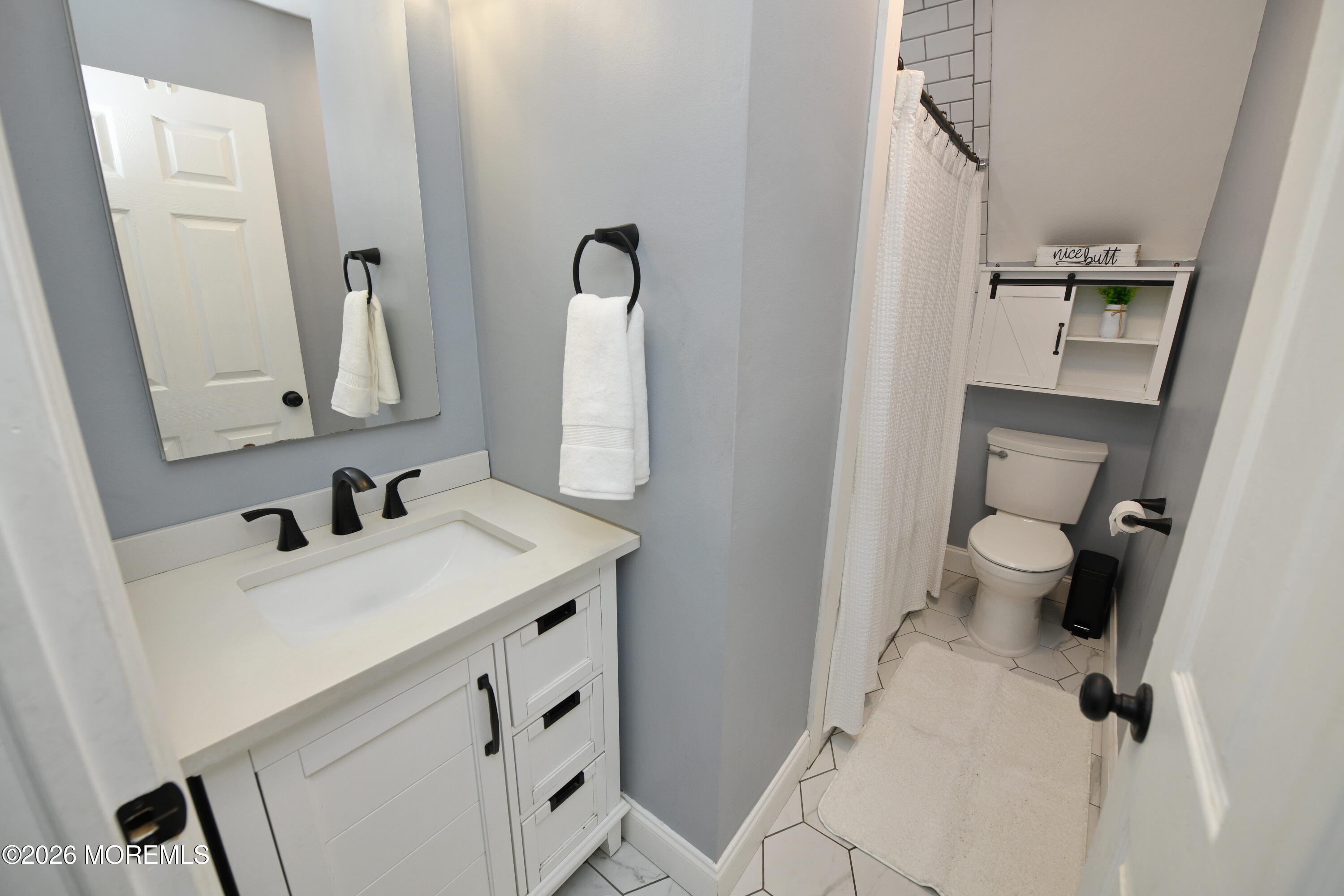 232 Pearce Avenue Point Pleasant, NJ 08742 - Photo 18 of 27 a bathroom with a sink vanity mirror and toilet