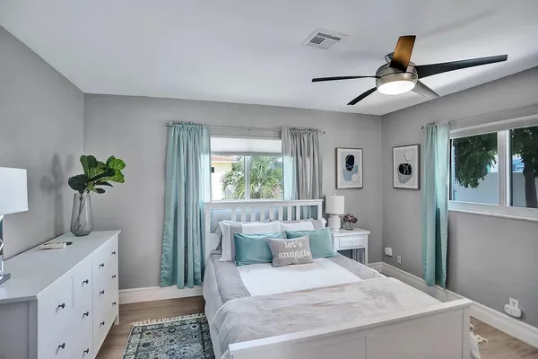 a bedroom with a bed and a potted plant