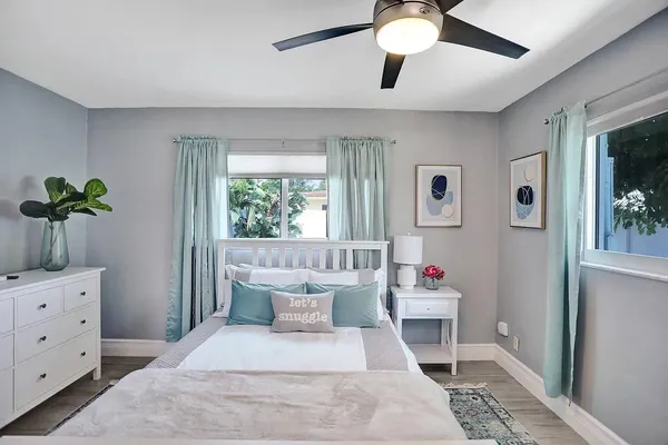 a bedroom with a bed and a chandelier