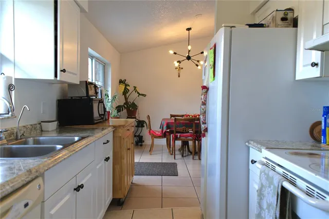 a kitchen with a sink appliances and cabinets