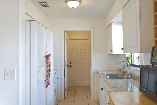 a kitchen with a refrigerator and cabinets