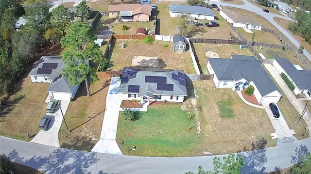 an aerial view of residential houses with outdoor space