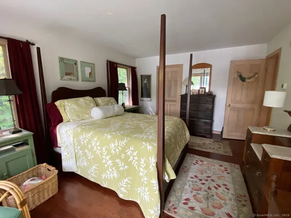 a bedroom with bed and window