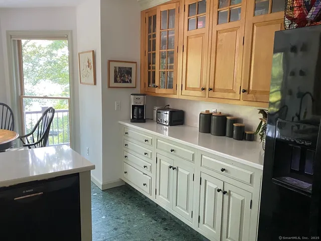 a kitchen with a table chairs a sink dishwasher stove and cabinets