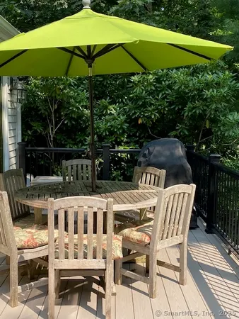 a view of a chairs and table under an umbrella in the patio