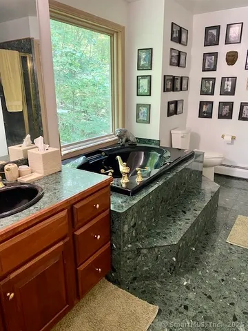 a living room with furniture stove and large window
