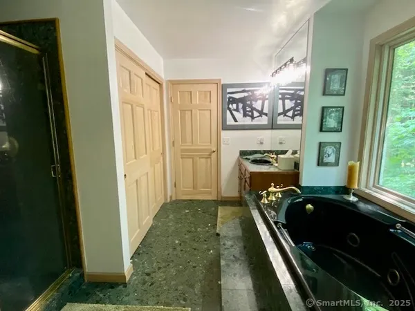 a living room with furniture stove and large window