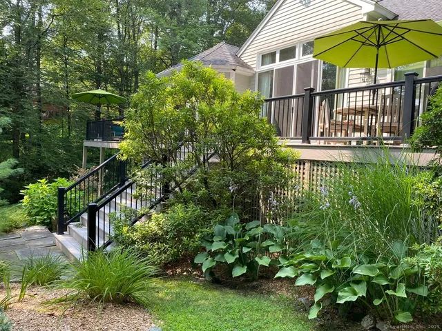 a view of a house with a yard and potted plants