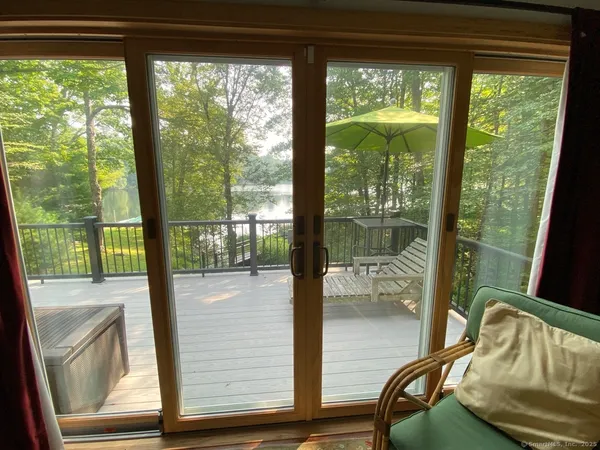 a view of a glass door with a chair
