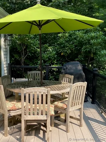 a view of a chairs and table under an umbrella in the patio