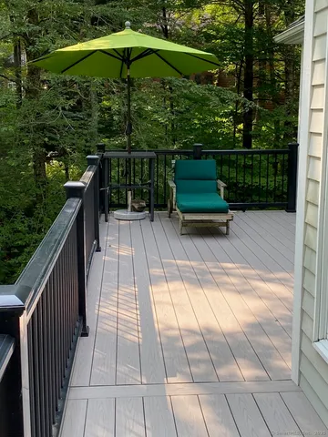 a view of backyard with seating space and trees