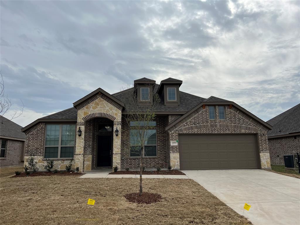 277 Eagle Ridge Forney, TX 75126 - Photo 2 of 19 French country style house with brick siding, a shingled roof, stone siding, driveway, and a garage