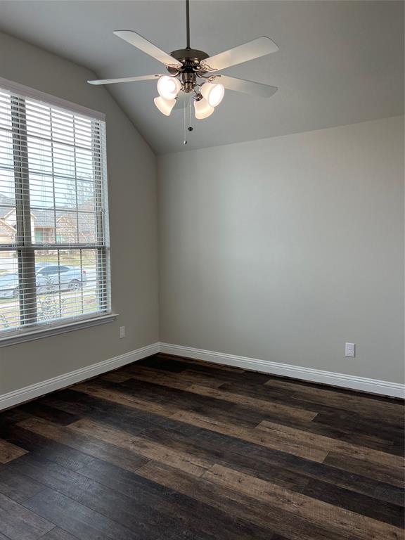 277 Eagle Ridge Forney, TX 75126 - Photo 10 of 19 Empty room featuring vaulted ceiling, dark wood finished floors, and a ceiling fan