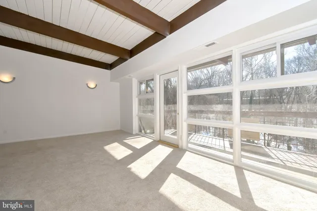 a view of an empty room with a balcony