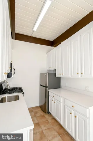 a kitchen with stainless steel appliances a sink a stove and a refrigerator