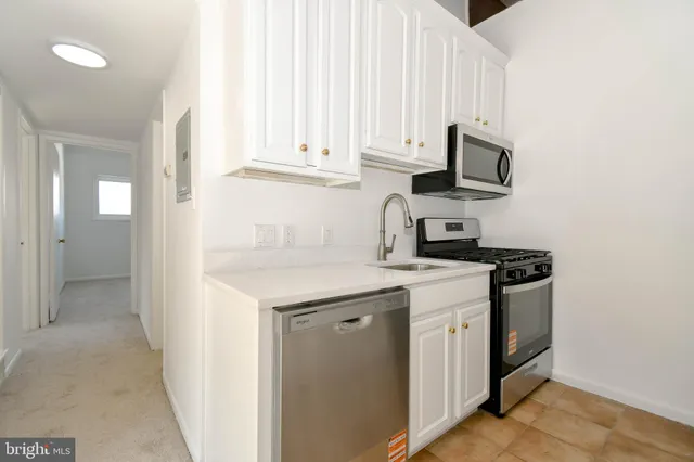 a kitchen with stainless steel appliances granite countertop a sink and a stove