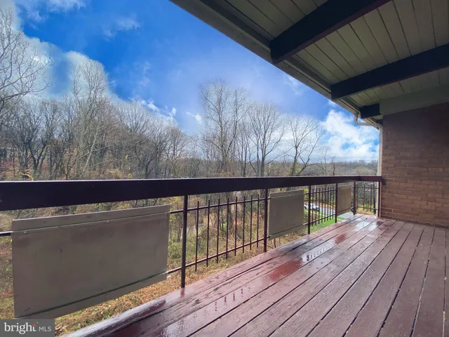 a view of a balcony with wooden floor