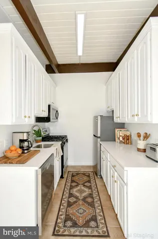 a kitchen with a sink a stove and cabinets