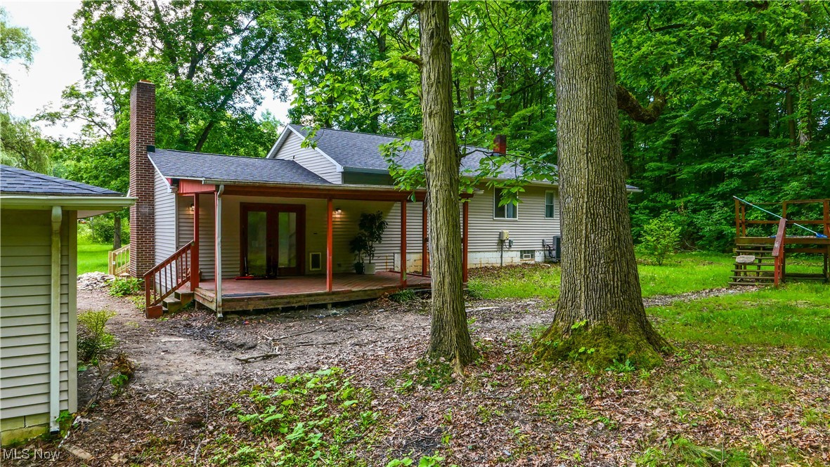 4869 Phillips Rice Road Cortland, OH 44410 - Photo 23 of 33 Back of house featuring a chimney, a shingled roof, and french doors