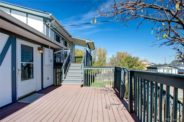 a view of a house with wooden deck