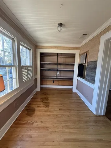a view of walk in closet with empty racks
