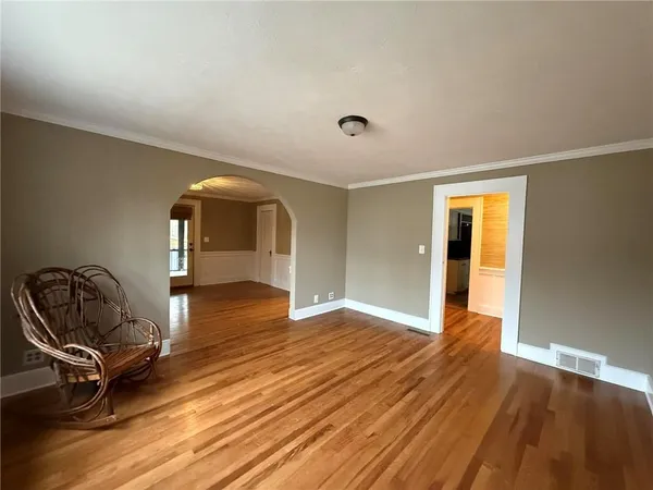 a view of room with window ceiling fan and hardwood floor