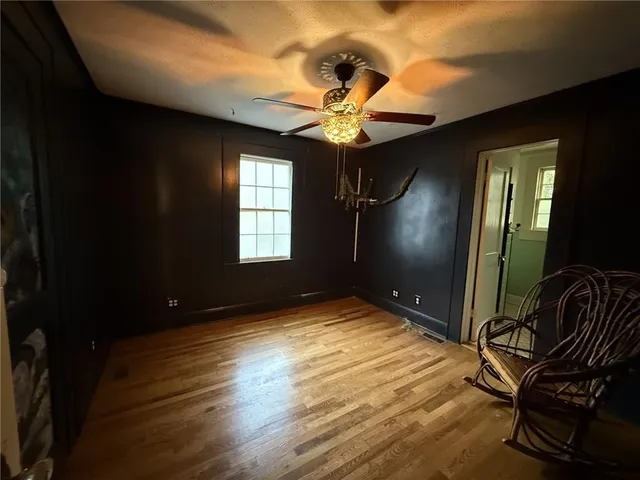 a bathroom with a granite countertop toilet and a sink
