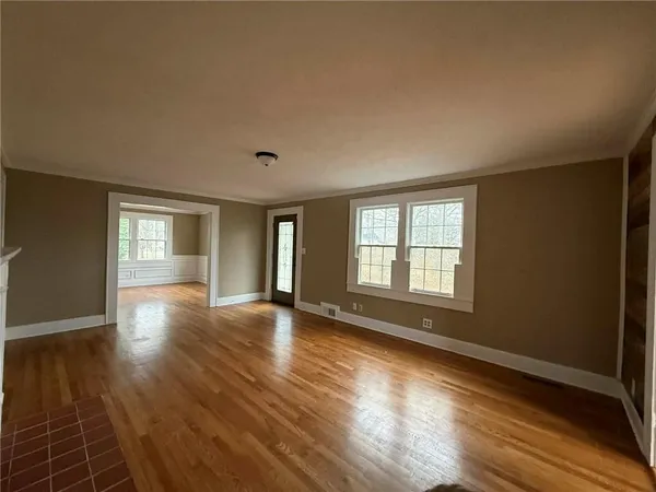 a view of a hallway with wooden floor