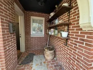 a view of a house with a outdoor space and a tree