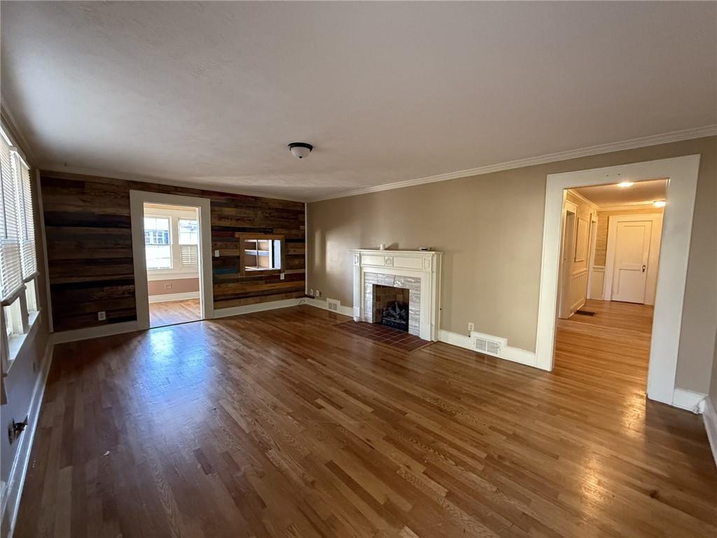 952 Wayside Street Cornelia, GA 30531 - Photo 5 of 50 an empty room with wooden floor and fireplace