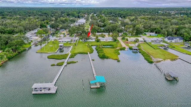 an aerial view of a house with a swimming pool yard and outdoor seating