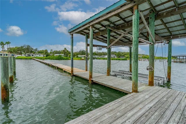 a view of a wooden deck with a lake view