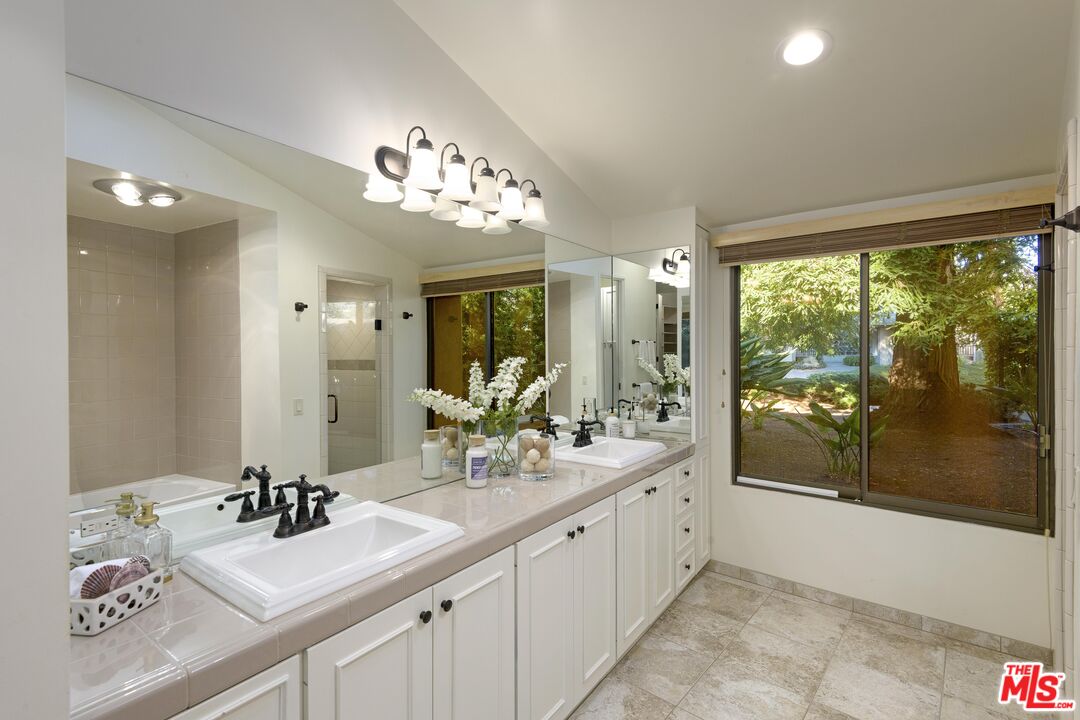 2141 10 Acre Road Santa Barbara, CA 93108 - Photo 13 of 21 a bathroom with a sink double vanity and a large mirror