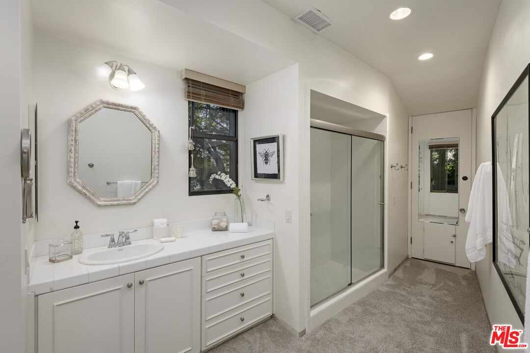 2141 10 Acre Road Santa Barbara, CA 93108 - Photo 15 of 21 a bathroom with a double vanity sink mirror and shower
