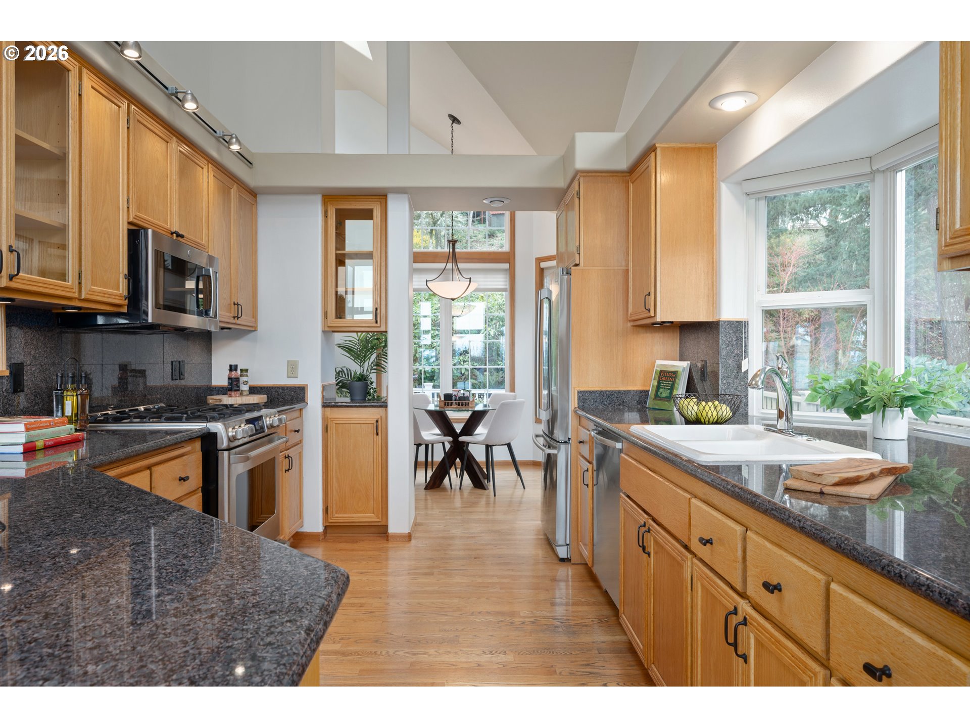 653 Brookside Drive Eugene, OR 97405 - Photo 17 of 48 a kitchen with stainless steel appliances granite countertop a stove a sink and a microwave