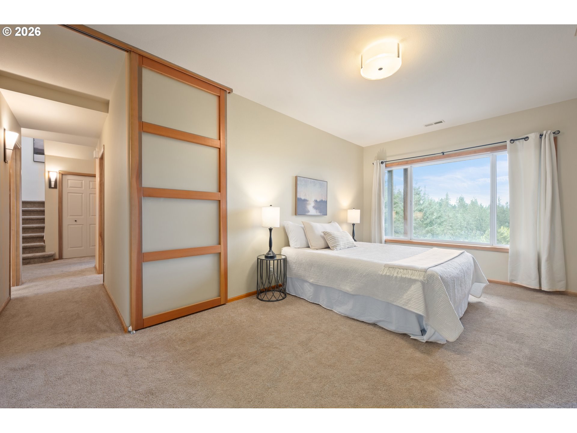 653 Brookside Drive Eugene, OR 97405 - Photo 32 of 48 a bedroom with a bed and a large window