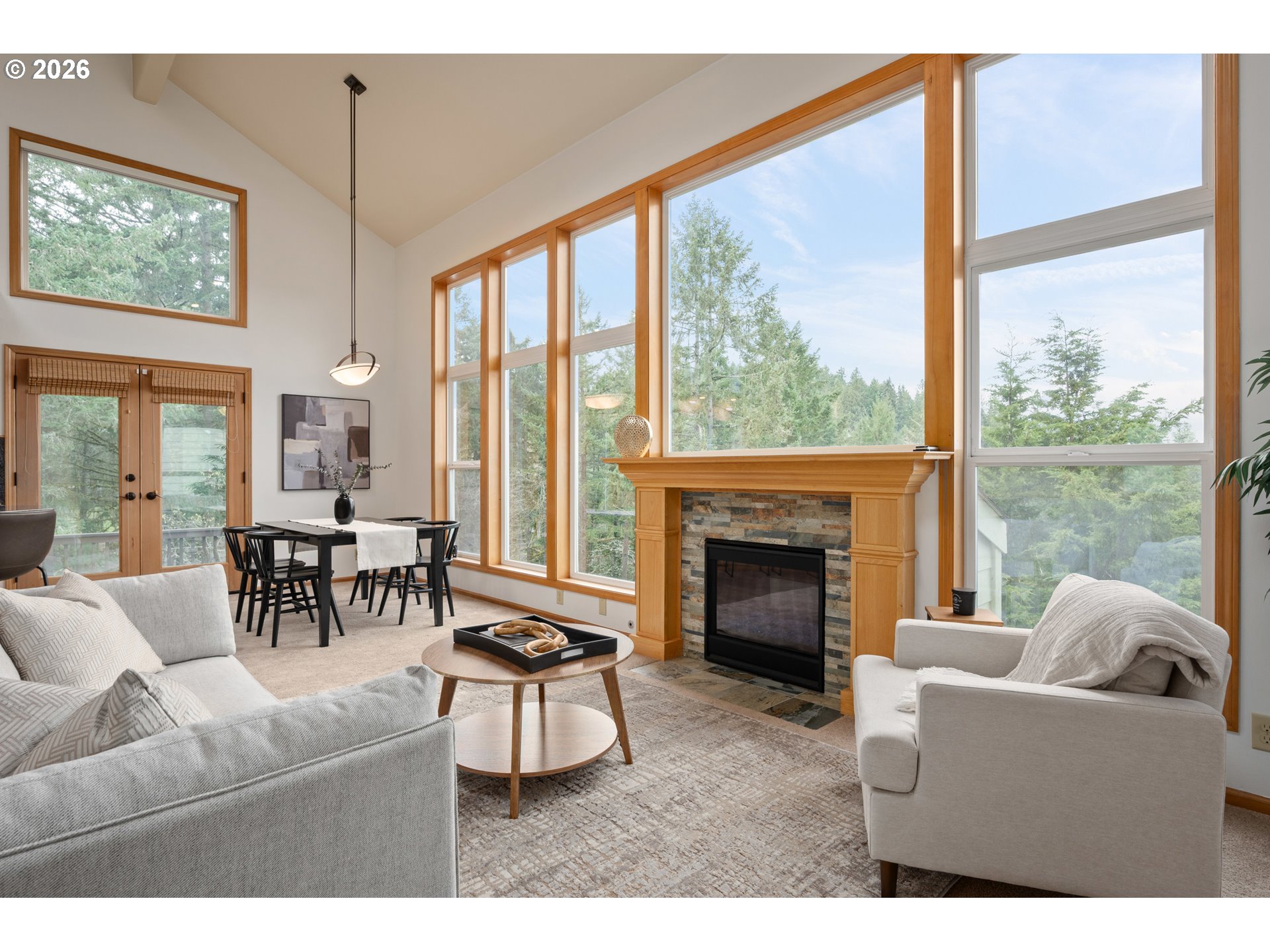 653 Brookside Drive Eugene, OR 97405 - Photo 6 of 48 a living room with furniture a fireplace and floor to ceiling windows